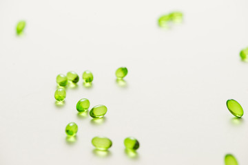 Top view many gel capsules on white background isolated. Vitamin E 200 mg capsules.