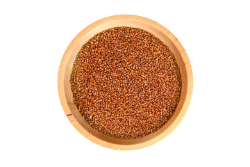 Obraz na płótnie Canvas Isolated closeup buckwheat in a round wooden plate