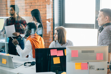 closeup portrait of young hardworking journalists with different nationalities listening to their chief