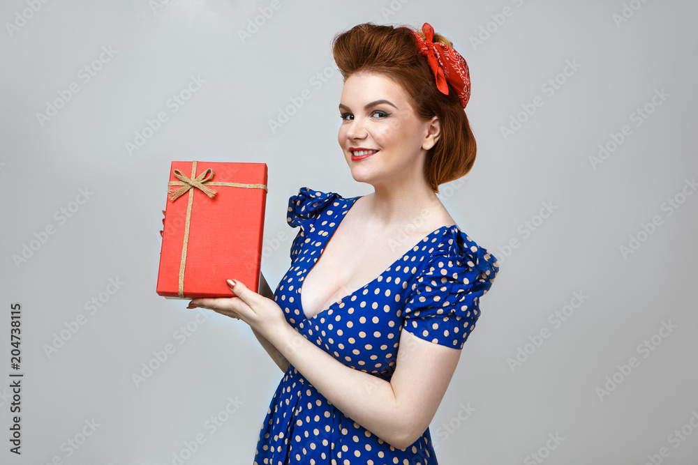 Wall mural people, lifestyle and holidays concept. studio shot of cheerful young european housewife in stylish 