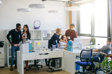 Obraz premium photo of cooperating mixed race office workers in the light room
