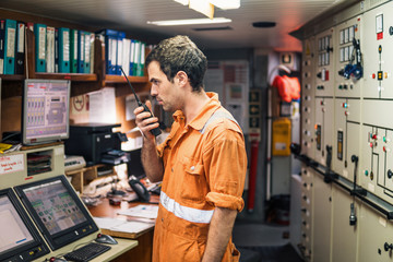 Marine Engineer working on radio communication at Engine Control room ECR. Vessel communication...