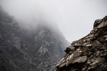 Panorama of the foggy winter landscape in the mountains with snow and rocks, Azerbaijan, Lahic, Big Caucasus