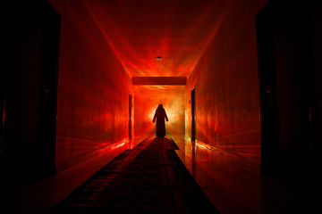 Creepy silhouette in the dark abandoned building. Dark corridor with cabinet doors and lights with silhouette of spooky horror person standing with different poses.