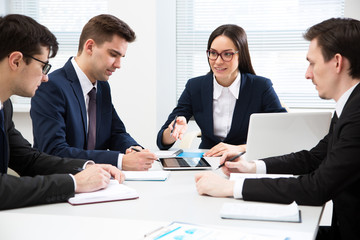 Businesswoman explains to businessmen a new project