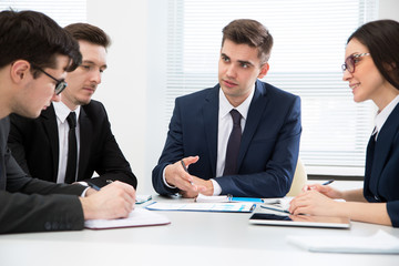 Businessman tells his colleagues about a new project