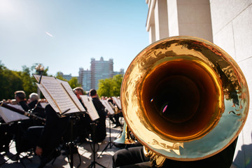 Unrecognizable musician with tube. Alto horn close up. Entertainment to citizens and tourists....