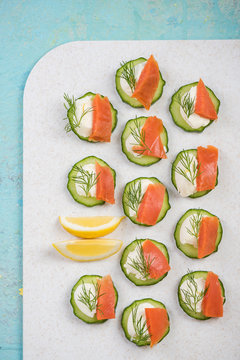Cucumber canapee with cottage cheese and salmon.