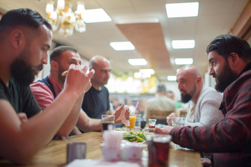 Muslim people enjoying a traditional Iftar meal