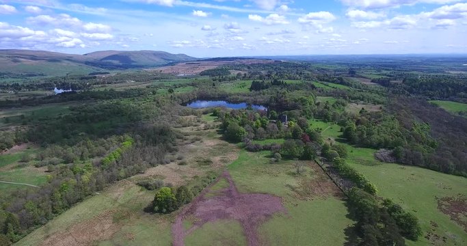 Aerial footage over Mugdock Country Park near Milngavie in Central Scotland.