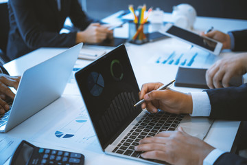 Fototapeta premium Business people discussing in meeting room using laptop for checking graph finance. Teamwork successful Meeting Workplace strategy Concept.