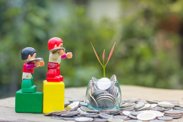 A coin in a glass bottle with a small tree on top and a coin beside it, Money Saving Ideas, Business Growth