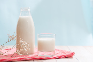 Dairy products. Bottle with milk and glass of milk on wooden table