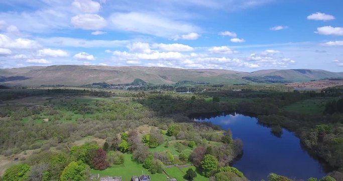 Aerial footage over Mugdock Country Park near Milngavie in Central Scotland.