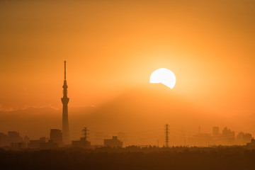 .Tokyo Fuji diamond with Tokyo Skytree landmark.  Diamond Fuji is View of the setting sun meeting the summit of Mt. Fuji
