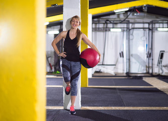 portrait of woman with red crossfitness ball