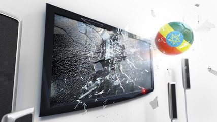 Soccer ball with the flag of Ethiopia kicked through a shattering tv screen.(3D rendering series)