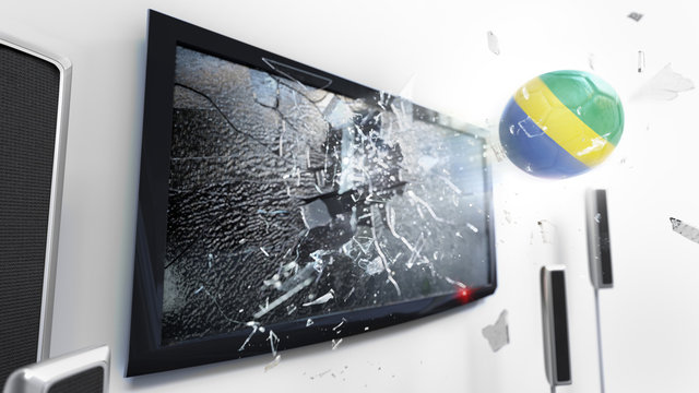 Soccer ball with the flag of Gabon kicked through a shattering tv screen.(3D rendering series)