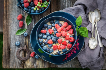 Closeup of oat flakes with fresh berries in garden