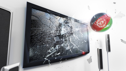 Soccer ball with the flag of Afghanistan kicked through a shattering tv screen.(3D rendering series)
