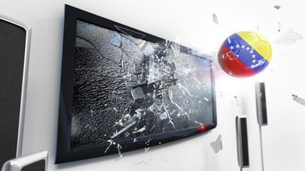 Soccer ball with the flag of Venezuela kicked through a shattering tv screen.(3D rendering series)