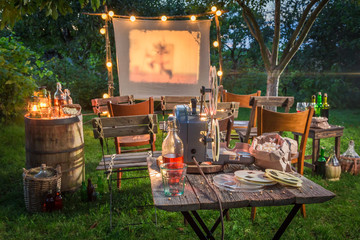 Open air cinema with retro projector in summer garden © shaiith