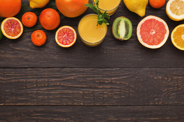 Variety of ripe citruses on wooden background