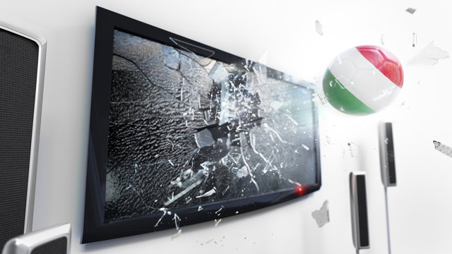Soccer ball with the flag of Hungary kicked through a shattering tv screen.(3D rendering series)
