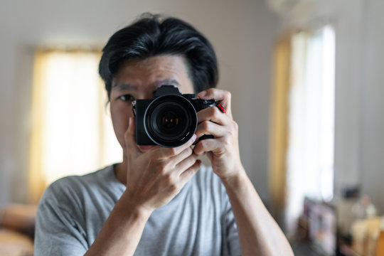 a man taking photography by digital mirrorless camera