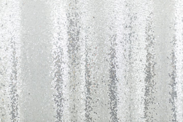 Silver sequins pattern texture fashion background. Horizontal close-up shot.