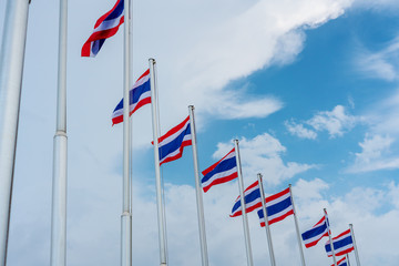 Thailand flags on flagstaff against blue sky and white clouds