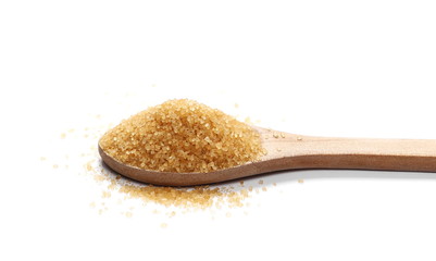Brown sugar cane and wooden spoon isolated on white