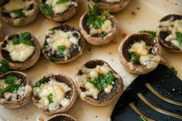 Cheesy mushrooms and spatula on plate
