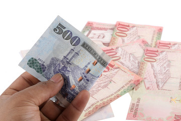 Saudi man counting thousands Saudi Riyal isolated on white background