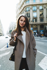 Elegant business woman enjoying walking the city after hard working day. Student girl in a trendy...