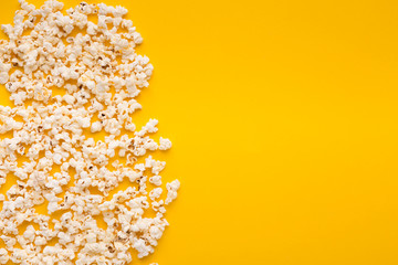 Slaty popcorn scattered on yellow background, top view