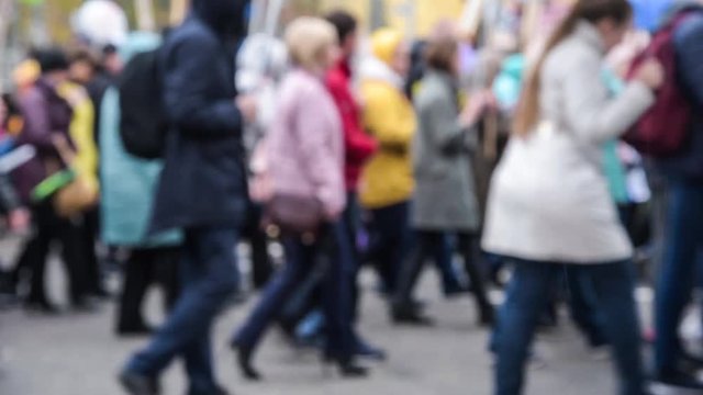 many people walk down the street. blurred.