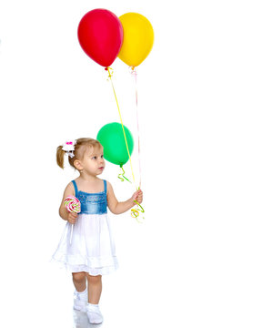 Little girl is playing with a balloon