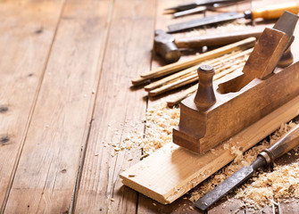 old tools: wooden planer, hammer, chisel  in a carpentry workshop