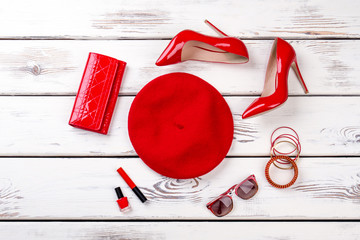 Collage of female red fashion accessories. Stylized flat lay of ladies red beret, heels, purse and...