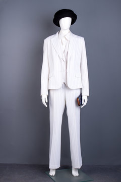 Mannequin in white suit and black hat. Women formal style classy suit. Feminine brand clothes and accessories.