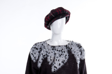 Black and red cap for women. Feminine black sweater with white pattern. Women fashion and style.