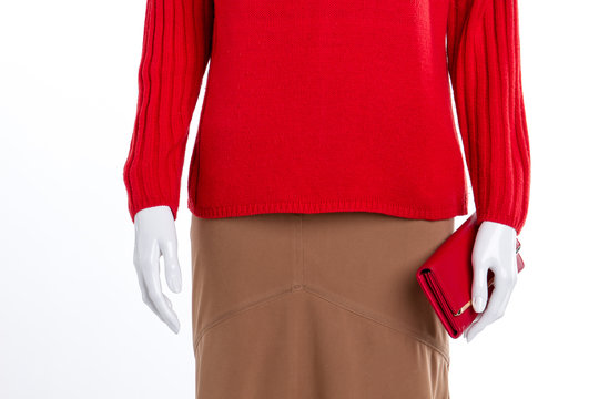 Close up red women sweater and wallet. Warm pullover and skirt for women. Women clothes and accessories.