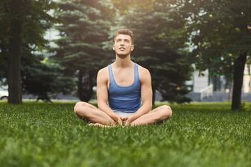 Young man practicing yoga, relax meditation pose