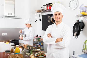 Adult man chef cooking food at kitchen