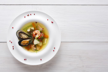 Healthy delicatessen seafood soup of white fish, shrimps and mussels
