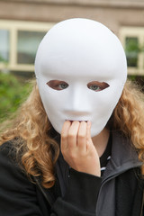 Girl with white mask. He is afraid of something.