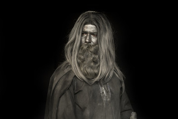 long haired man made of gray make up; mythological bearded man