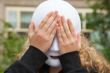 Girl with a mask covering her eyes