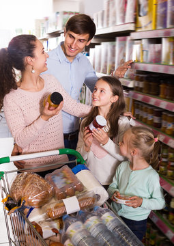 Adult customers with small kids  purchasing jam
